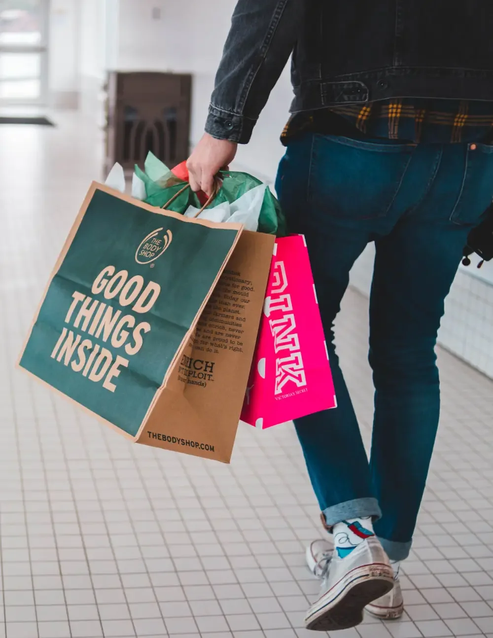 man carrying paper bag shopping